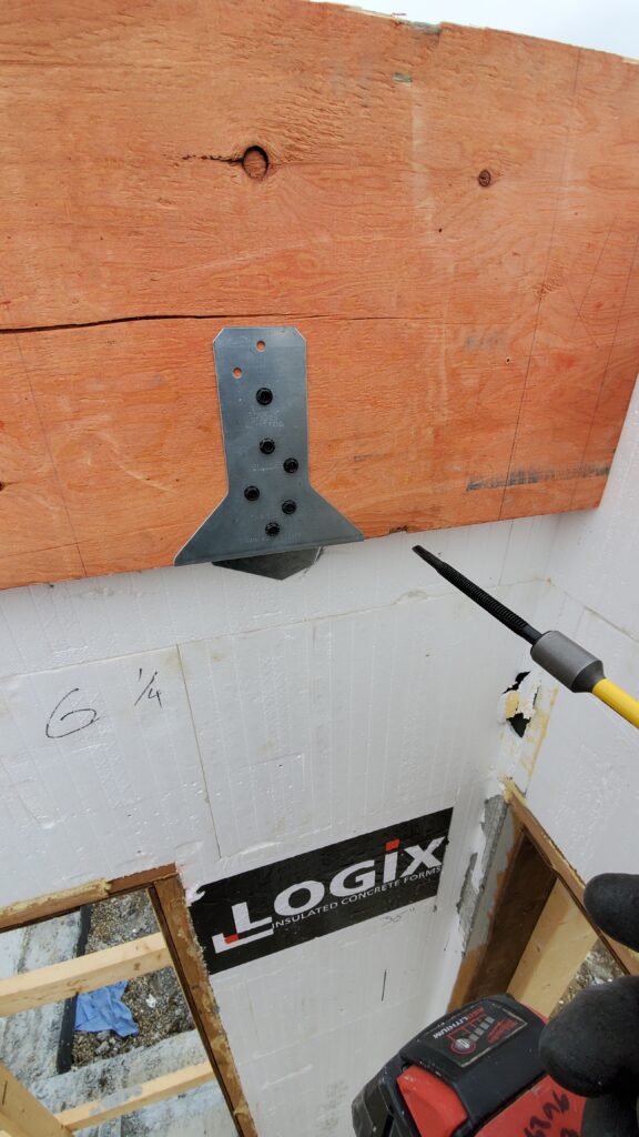 A Simpson Strong-Tie ICFVL hanger securely fastened to an LVL ledger, providing robust structural support against a Logix ICF wall.