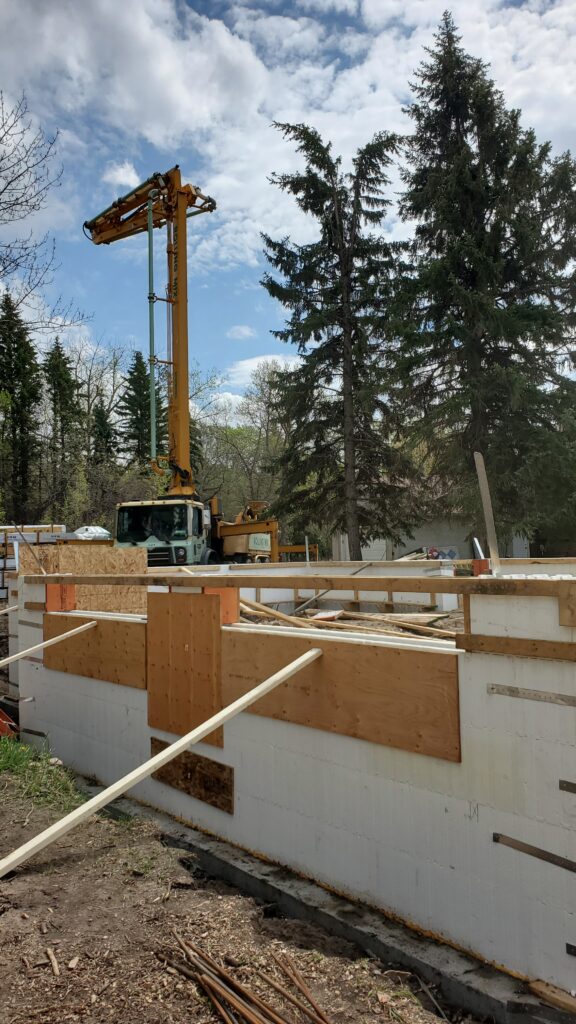 Concrete pump in action - the crucial choice for a flawless ICF foundation pour in Edmonton, ensuring efficiency and long-lasting results..