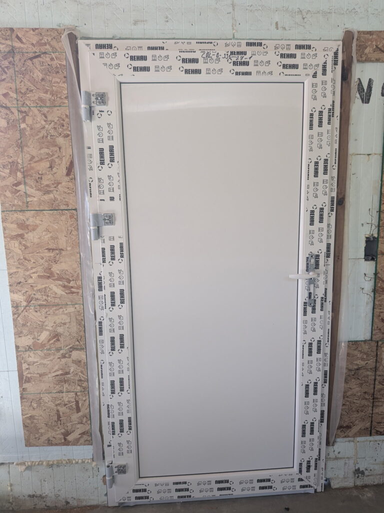 Finished insulated door installed in an ICF wall during an Edmonton construction project.