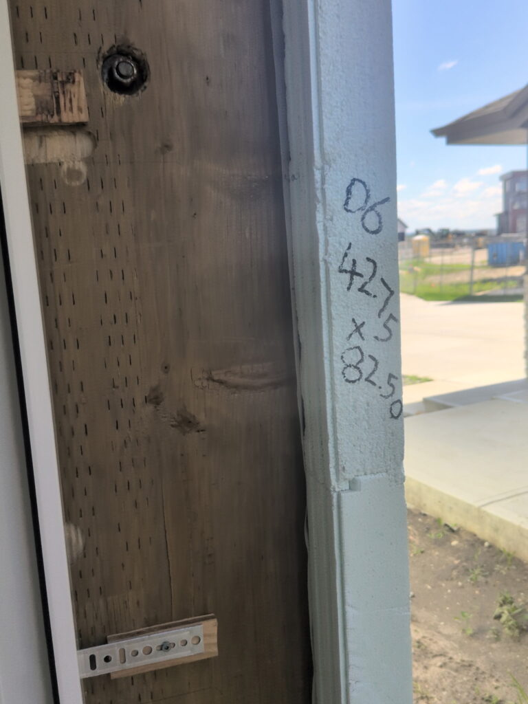 Pressure-treated 2x12 door buck installed in an ICF wall opening in Edmonton before concrete placement.